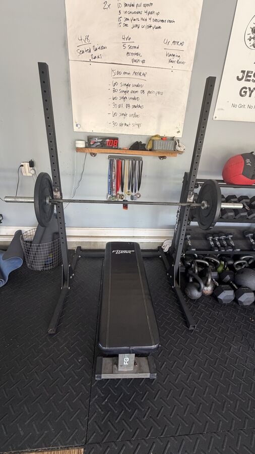 Squat rack and bench with the WOD board