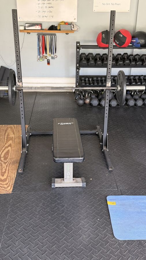Squat rack under the No Grit No Pearl sign